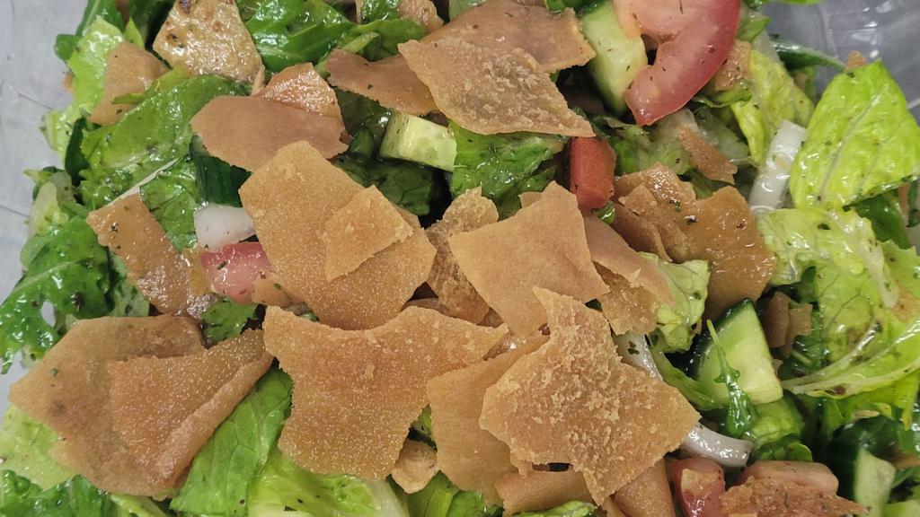 Fattoush Salad Plate · Chopped romaine lettuce onions tomatoes dried mint with the special house dressing crispy pita bread on top.