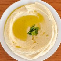 Hummus · Chickpeas puréed with tahini sauce, fresh lemon juice, and a hint of olive oil. Served with ...