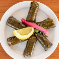 Dolmas · Tender grape leaves stuffed with rice, spices, and herbs in olive oil.