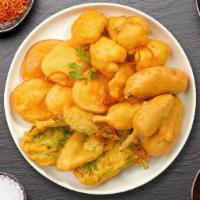 Bite The Pakoras · A popular Indian street food! Fresh vegetables, coated in spiced gram flour and deep fried.