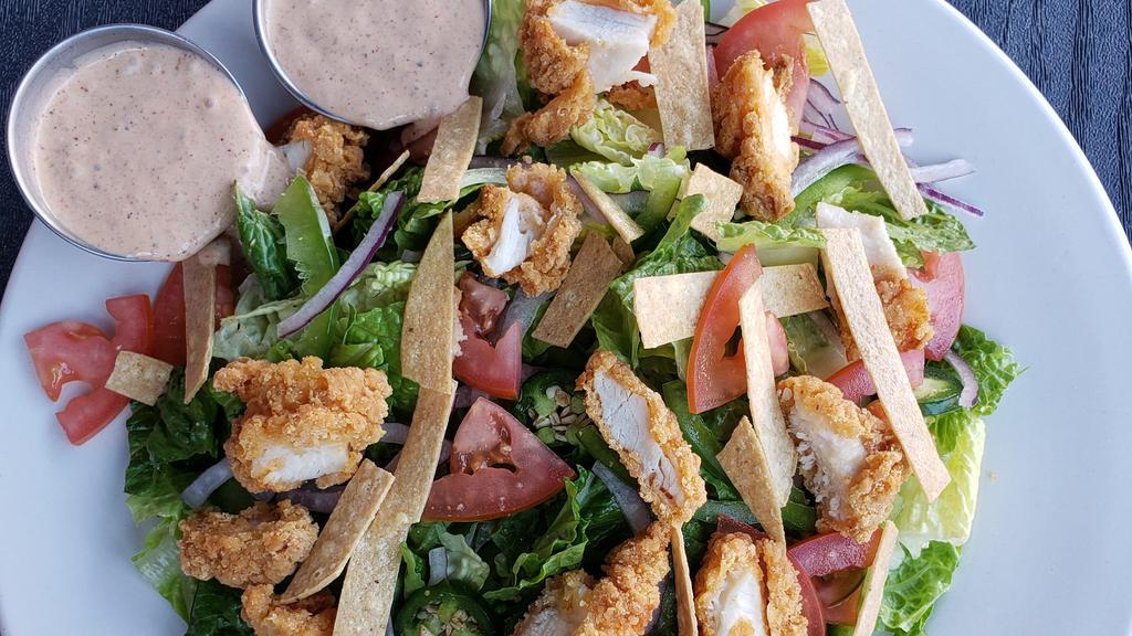 Southwest Caesar · Crisp romaine, thin bell peppers slices, tortilla strips, chopped tomatoes, red onion, julienned jalapeno slices, southwestern Caesar dressing.