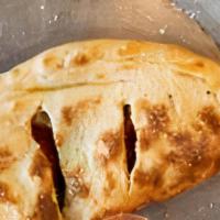 Calzone · Our scratch made pizza dough, folded stuffed with mozzarella and ricotta cheeses. Includes 1...