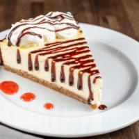 Cheesecake Slice · Our homemade cheesecake with graham cracker crust. Chocolate or strawberry syrup upon request