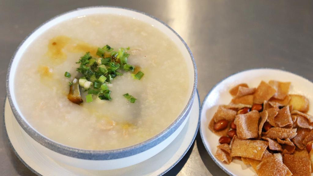 Pork Porridge 皮蛋瘦肉粥 · White rice oatmeal with diced pork and preserved egg, come with crispy crackers.
