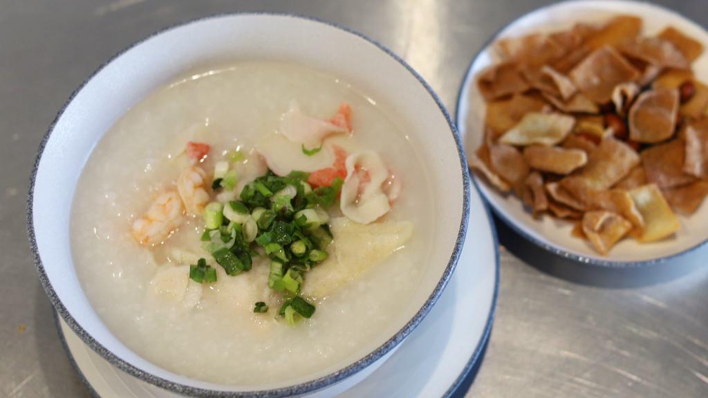 Seafood Porridge 海鲜粥 · White rice oatmeal with shrimp, calamari, and fish. Come with crispy crackers.