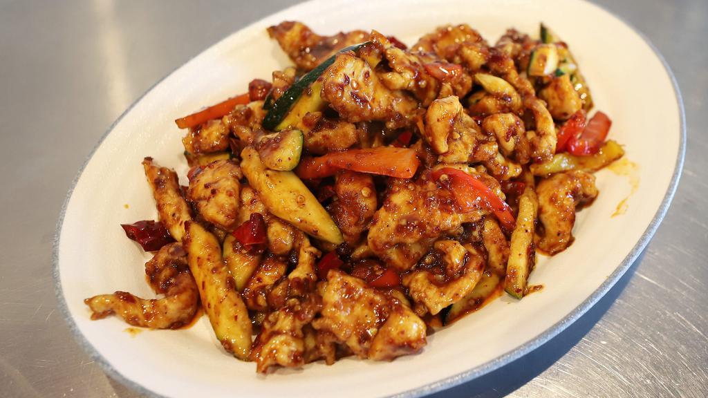 Kung Pao Chicken 宫保鸡丁 · Diced chicken stir-fried with zucchini, bell pepper, and peanuts.