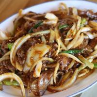 Mongolian Beef 蒙古牛 · Beef tenderloin slices stir-fried with onion and seafood sauce.