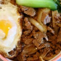 Poached Egg Beef Rice 窝蛋牛肉饭 · Beef tenderloin slices stir-fried with onions and chef's gravy, topped with one sunny egg