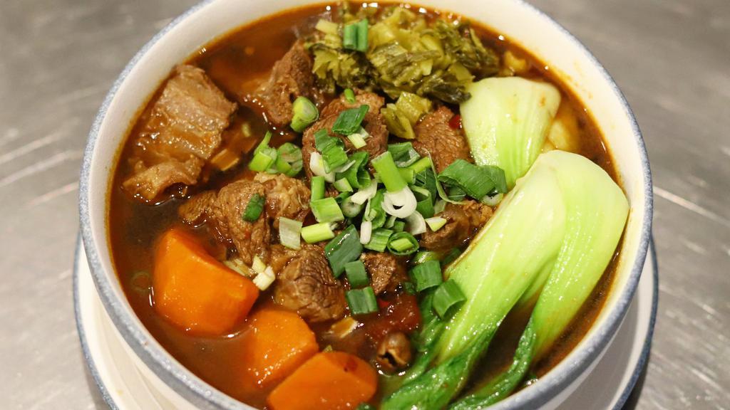 Taiwan Beef Shank Soup Noodle 台式红烧番茄牛肉面 · Stewed beef shank chops with house spice, onion, and tomato. Comes with buk-choy and carrots. Light spicy, fixed soup base.