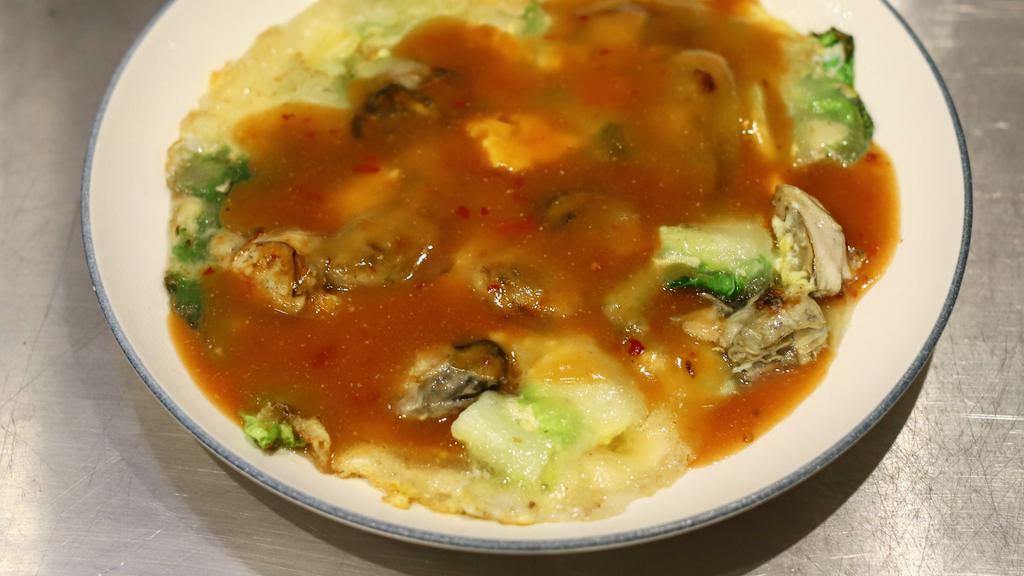 Oyster Omelet 蚵仔煎 · Taiwan special omelet stir-fried with fresh shucked oysters and Chinese cabbage, topped with chef's sauce