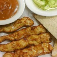 Chicken Satay · (4 pieces) marinated tender chicken breast skewers in herbs and spices, served with a side o...