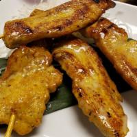 Thai Street Chicken Satay · 4 pieces. Marinated in Thai curry powder and herbs, served with peanut sauce and fresh cucum...