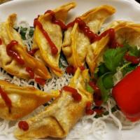 Gyoza · Pork pot stickers served with ginger soy sauce.