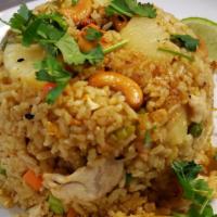 Pineapple Fried Rice · Pineapple, cashew nuts, green onions, peas, carrots, and egg, served with cucumber, cilantro...