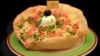 Arriba® Taco Salad · Your choice of shredded chicken, shredded beef or ground beef, charro beans, onions and chee...