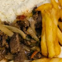 Lomo Saltado · marinated strips of sirloin with onions, tomatoes, french fries and rice on the side