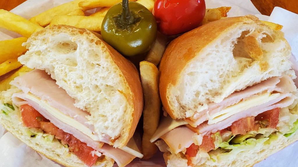 Turkey And Swiss · Freshly sliced Turkey served on a mini loaf with mayo, lettuce and tomato. Your choice of Grilled or Cold.