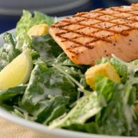 Caesar Salad With Grilled Wild Alaskan Salmon · Wild Alaskan Salmon Filet served on a Caesar Salad with croutons, Parmesan Cheese and Caesar...
