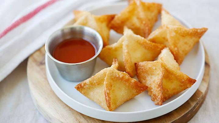 Fried Cheese Wonton (6 Pc) · Crispy cream cheese wontons are stuffed with the most delicious filling with crispy exterior and hot melty interior