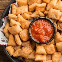 Dough Nuggets · Bite-sized pieces of crispy pizza dough tossed in garlic butter sauce, romano cheese & orega...