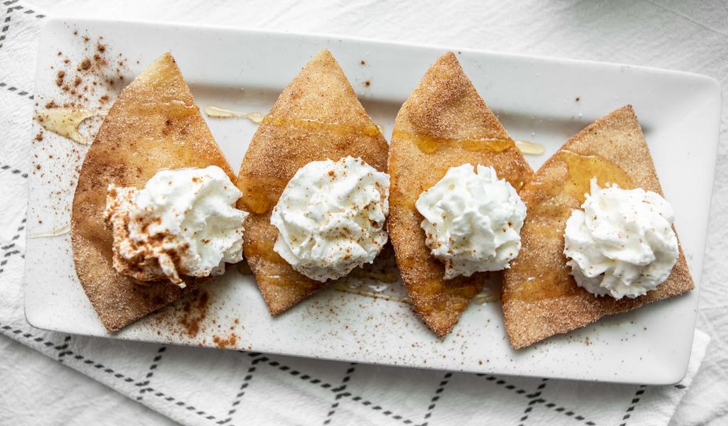 Sopapillas · A crispy honey coated flour tortilla topped with sugar, cinnamon, and whipped cream.