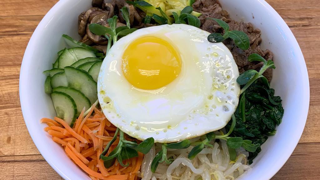 Bibimbap · A traditional Korean mixed rice bowl with cucumbers, green and yellow zucchini, carrots, spinach, bean sprouts, and mushrooms topped with a beautiful egg along with your choice of meat (Bulgogi Beef, Spicy Pork, Shrimp, and Tofu)<br />