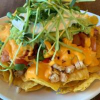 Nacho With Chicken And Microgreens · Nachos with corn tortilla chips, our store-made salsa, melted cheese, sour cream, guacamole,...