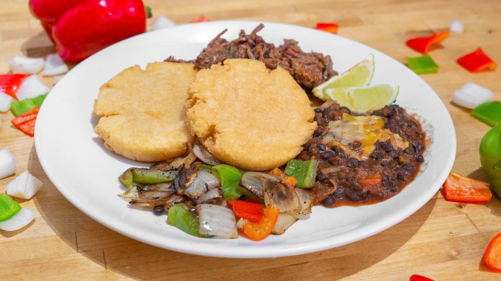 Chopped Brisket Arepa Plate · House Smoked Beef Brisket, Two Arepas, Black Bean Chili topped with cheese, Grilled Peppers and Onions.