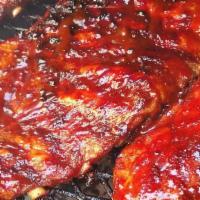 (1/2) Slab Of Ribs · Served with THE PLUGG BBQ Sauce