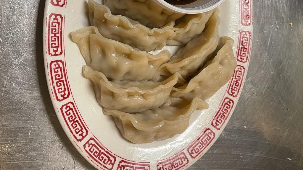 Steamed Dumplings · Choice of pork or chicken filled dumplings steamed, served with a side of house dipping sauce and garnished with broccoli.