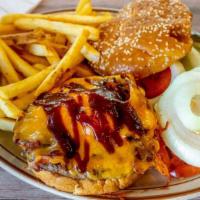 Cowboy Burger · Topped with bacon, cheddar cheese and BBQ sauce. served with fries.