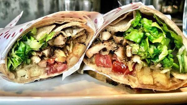 Shawarma (Halal) · Top seller. Shawarma spiced chicken, lettuce, tomato, pickles, frites, roasted garlic sauce.
