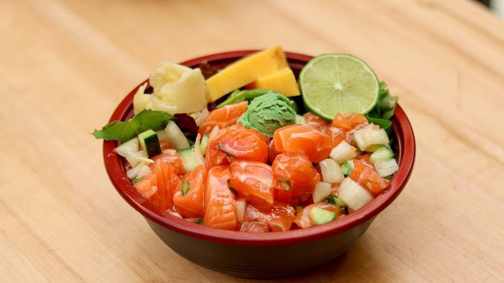 Salmon Poke Bowl · The Salmon Poke Bowl contains rice and mixed greens. It contains 2 scoops of raw salmon poke. The Salmon Poke contains raw salmon chunks, sweet onions, cucumbers, green onions, sea salt, and sesame oil. Salmon Poke is gluten-free. The Salmon Poke Bowl contains complimentary tamago (not gluten-free), ginger, and wasabi.