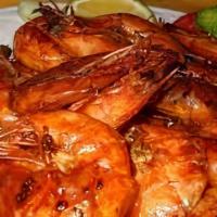 Camarones Cucarachos · shrimp marinated in a spicy sauce and golden to perfection. served with cucumber slices with...