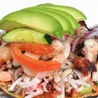 Tostada Mixta · tostada toped with crab, octopus and cooked shrimp mixed with tomato, onion and lemon.