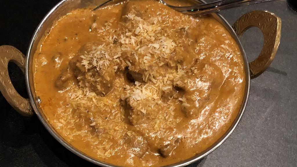 Lamb Coconut Curry · Lamb chops cooked with coconut milk, fresh tomatoes, onions, garlic, ginger, cashew nuts, golden raisins and spices.
