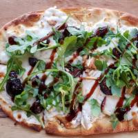 Washington Valley Flatbread · White wine-soaked figs, slivered almonds on pear whipped goat cheese smear, topped with mozz...