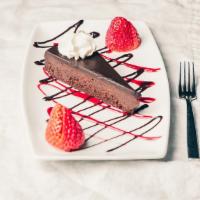 Flourless Chocolate Torte · Gluten free. Rich, dense slice of chocolate torte drizzled with raspberry coulee.