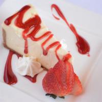 House Cheesecake · Slice of classic cheesecake with raspberry sauce and seasonal fruit.