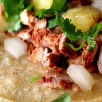 Al Pastor · Grilled pork marinated with spices and citrus juices, topped with cilantro, onion, and pinea...
