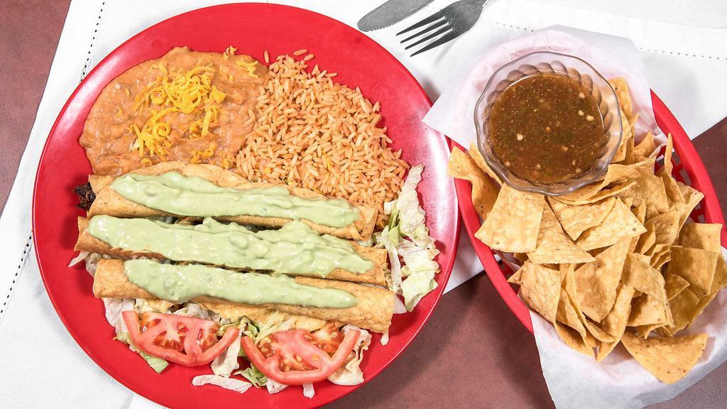 Flauta Plate Large · Three large rolled  tacos with your choice of beef or chicken served on a bed of lettuce. with guacamole slathered on top side of salsa and beans and rice