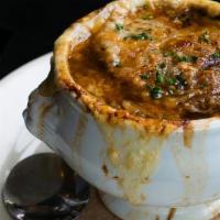 French Onion Soup · Classic French onion soup topped with crostini, gruyere and parmesan cheeses