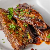 Costillas Bbq / Bbq Ribs · Select garlic, chimichurri, or buffalo and two sides of your preference.