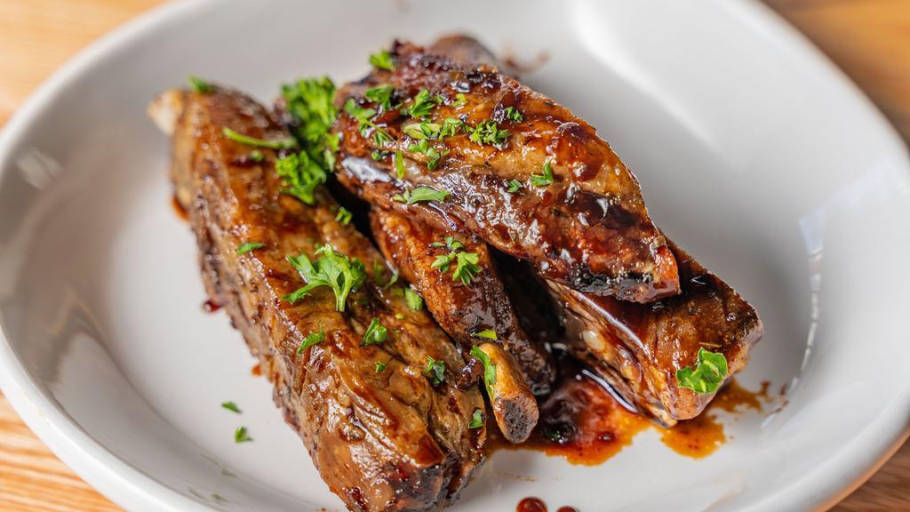 Costillas Bbq / Bbq Ribs · Select garlic, chimichurri, or buffalo and two sides of your preference.