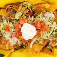 Trash Nachos With Chili · Pieces of deep-fried corn tortilla chips with a chopped gourmet burger patty, smothered in o...