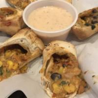 Southwestern Rolls · Hot and spicy egg rolls with chicken, cheese, black beans, corn and jalapenos served with bo...