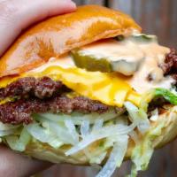 Classic Cheeseburger · 1/4 lb beef, American cheese, white onion, shredded iceberg, pickles, jojo sauce, butter roll.