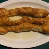 Breadsticks · Four of our famous breadsticks slathered in garlic butter and Parmesan and served with marin...