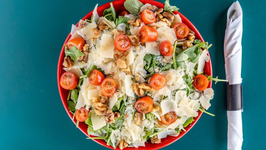 Arugula Salad · Arugula tossed with cherry tomatoes, olive oil, salt, pepper and fresh lemon juice. Topped with shaved Parmesan and walnuts