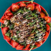 Strawberry Fields Spinach Salad · A bed of spinach topped with fresh strawberries, toasted almonds, red onion, crisp bacon, fe...